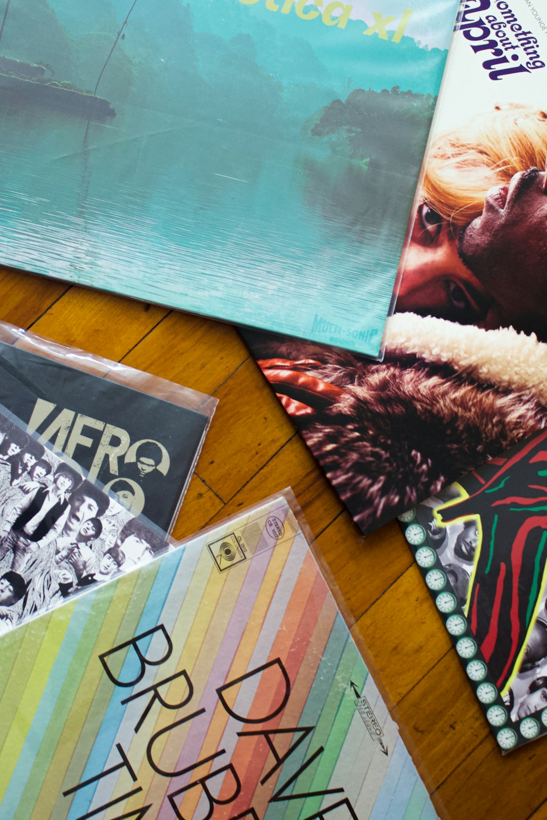 a-table-topped-with-magazines-and-magazines-on-top-of-a-wooden-floor-1mssblqrbm4